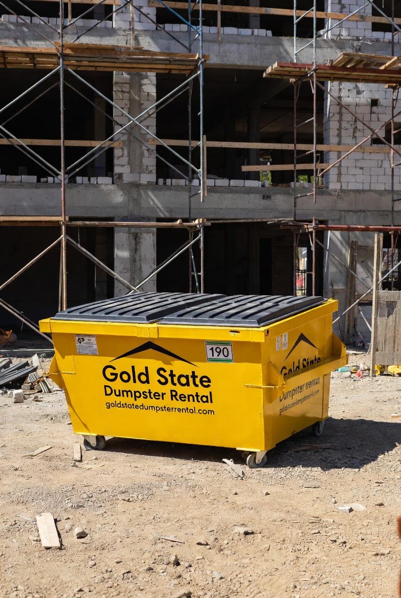 Gold state dumpster rental branded dumpster construction zone